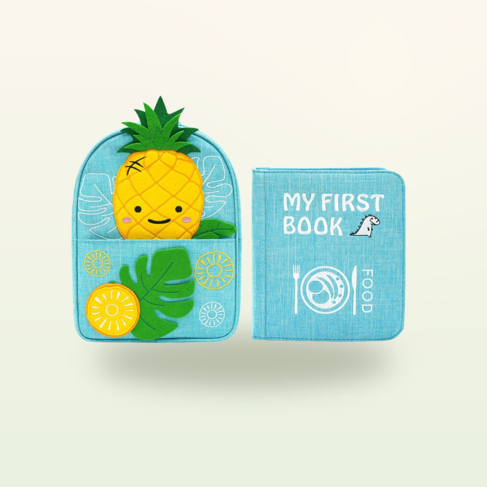 Kleine Feinschmecker Montessori Quiet Book mit passendem Ananas-Rucksack auf sanftem Creme-Hintergrund – ab 1 Jahr